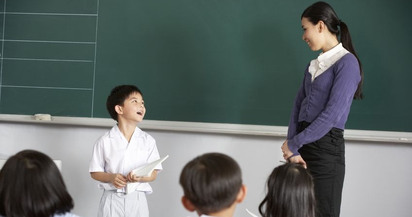 Student learning in class with teacher